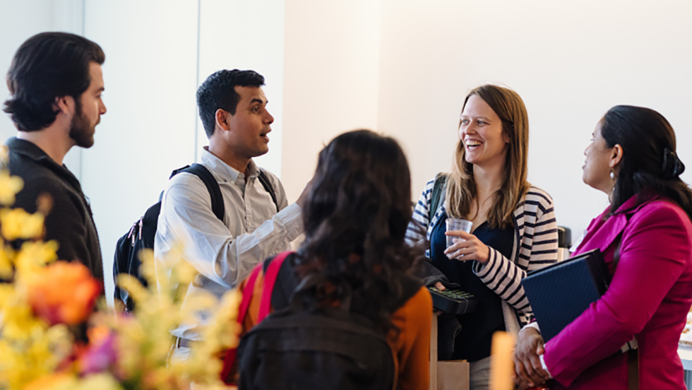 Postdocs conversing in a group